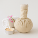 Kizhipotli — cloth massage bolus beside a candle